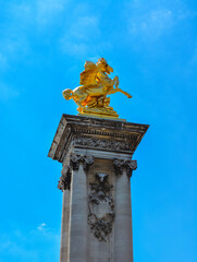 Canvas Print - Low angle shot of a Pont Alexandre III arch bridge with golden sculpture