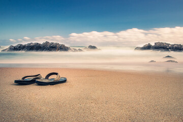 Poster - Shot of flip flops on the Plettenberg bay in summer