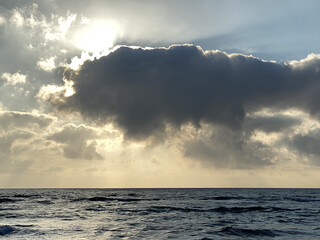 Wall Mural - Scenic view of sunlight behind clouds over the sea in Sardinien Meerblick