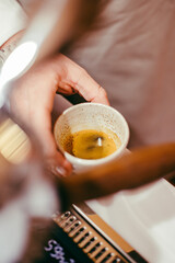 Sticker - Shallow focus top view of  man's hand holding a cup of espresso coffee