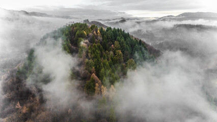 Wall Mural - aerial beautiful foggy view over green landscape mountains