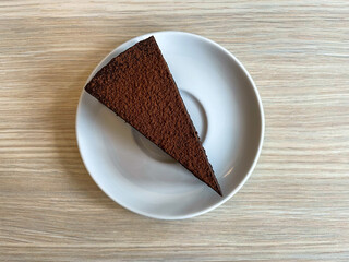 Sticker - A piece of chocolate cake sprinkled with cocoa.