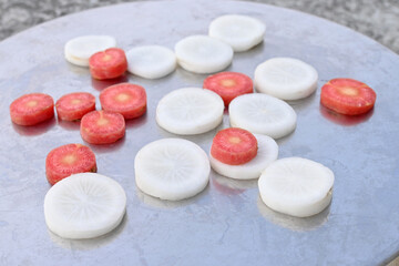 Poster - Closeup of sliced red carrots and white radish