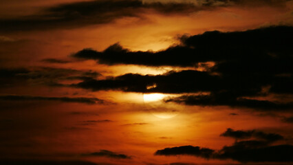 Wall Mural - beautiful shot of clouds covering the sun during the sunset