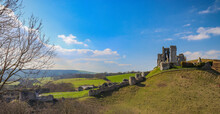 Corfe Castle On Hills In Isle Of Purbeck On A Sunny Day In Dorset, England