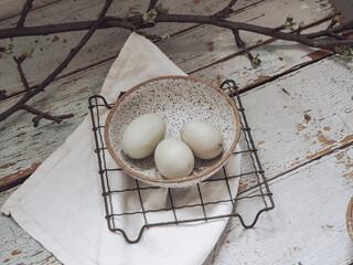 Wall Mural - Aesthetic close up shot of three eggs in a plate with black small dots