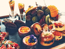 Assorted Food And Desert On Wooden Board
