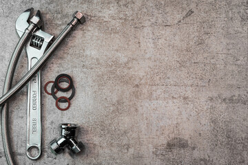 Poster - Adjustable wrench, pipes and gaskets on a marbled background.