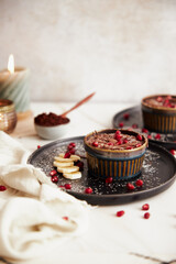 Sticker - Photo of a hot lava cake with banana and fruit on a black plate on a table and white background