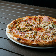 Wall Mural - Closeup of a pizza on a white plate