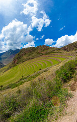 Poster - Vertical shot of a mountainous landscape on cloudy sky background