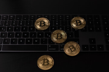 Poster - Closeup shot of bitcoins on top of a dark keyboard