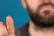 © Markus Glombitza/Wirestock - Closeup shot of a bearded male pointing with his finger