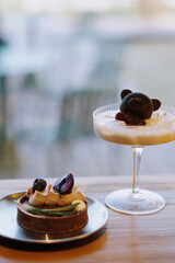 Canvas Print - Vertical shot of a cake and a cocktail on a table