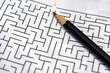 © Yilmazsavaskandag/Wirestock - maze puzzle game and pencil to solve