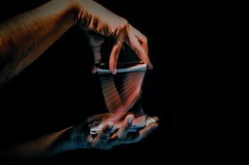 Sticker - Man's hand shuffling deck of cards with long exposure isolated on black background