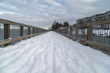 Sticker - Scenic view of a wooden bridge across a lake in winter