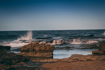 Poster - Scenic view of waves on a rocky shore