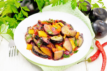 Wall Mural - Eggplant with plums in plate on light board