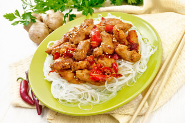 Wall Mural - Stir-fry of chicken with peppers in plate on light board