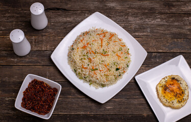 Canvas Print - Top view of delicious rice with carrot and other tasty meals on the wooden table