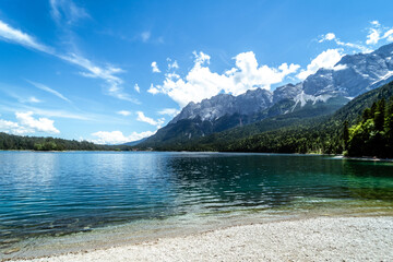 Tropical view of a blue lake surrounded by trees and mountains