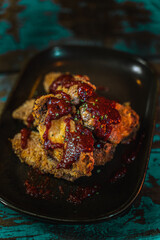 Poster - Tasty chicken wings dish in a dark grungy restaurant setting