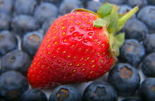 Closeup Shot Of A Fresh Strawberry And Blue Berries