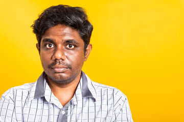 Closeup Asian happy portrait young black man standing cross arms chest confident pose and looking camera, studio shot isolated on yellow background