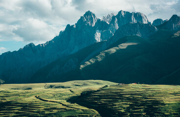 Wall Mural - Beautiful view of a field and mountains on a sunny day