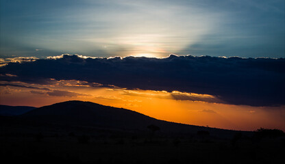 Wall Mural - Beautiful view of a sunset over mountains