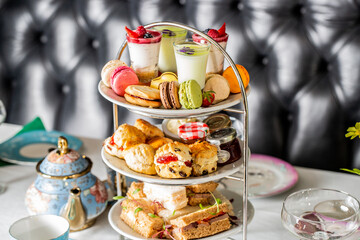 Poster - Served white table with a set of various desserts in the restaurant