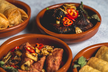 Canvas Print - Assortment of tasty and appetizing dishes in clay bowls