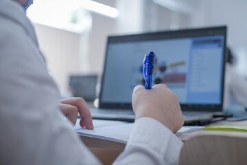 Poster - Closeup of a Romanian student writing on a notebook