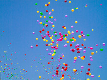 View Of Colorful Balloons Flying High In The Blue Sky On A Sunny Day