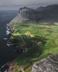 Wall Mural - Aerial view of a rock and the ocean on a foggy day