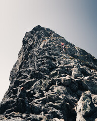 Canvas Print - Low angle shot of hikers on the rock