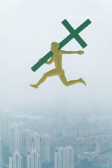 Canvas Print - Abstract background of an ilustration male holding a green cross over misty urban buildings