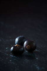 Wall Mural - Vertical shot of blueberries on a dark background