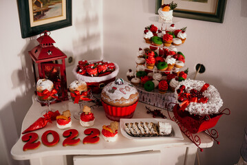 Wall Mural - Closeup of a Christmas table with delicious sweets and cakes