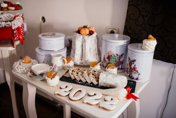 Wall Mural - Closeup of a Christmas table with delicious sweets and cakes