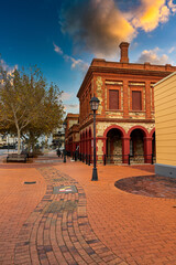 Canvas Print - Beautiful view of an old building with a park under the blue sky