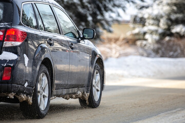 Wall Mural - Car driven on a road covered with snow