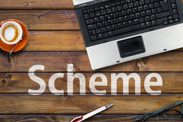 Scheme Programming Language. Word Scheme on wooden desk and laptop

