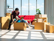 © MergeIdea - Asian young lover boy and girl are playing in the cardboard box while unpacking from moving relocation to new modern condominium
