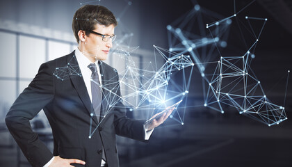 Canvas Print - Attractive young european business man using tablet with abstract polygonal network mesh hologram on blurry office interior background. Metaverse and AI concept.