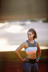 Poster - Feeling positive after her run. Cropped shot of an attractive young woman taking a run through the city.