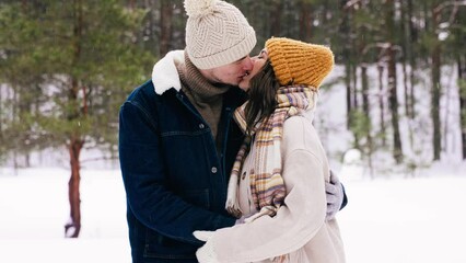 Poster - people, love and leisure concept - happy smiling couple kissing in winter park