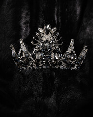 Wall Mural - beautiful silver crown with black stone for miss beauty pageant on black shiny background, close-up