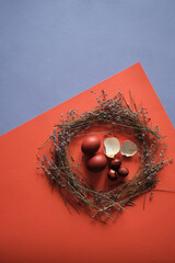 minimalism easter flat lay, easter lavender nest,  top view art color eggs and eggshell on a red orange purple background